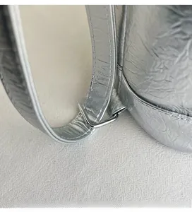 Detail of silver metallic textured tote with durable D-ring hardware and stitching
