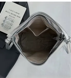 Spacious interior of silver metallic tote bag featuring a practical zip pocket and lining