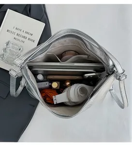 Spacious silver tote bag interior showing compartments for laptop, tablet, and cosmetics