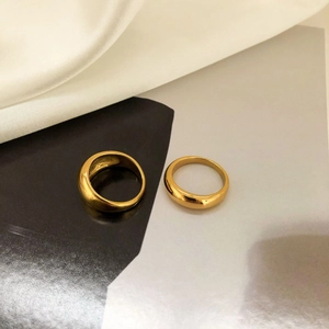 Minimalist gold round arc rings for women in a stackable set with polished metallic finish