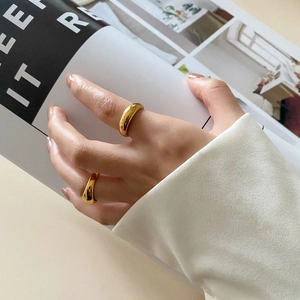 Close-up of minimalist thick dome gold plated rings on hand for a chic lifestyle look