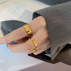 Polished 18k gold plated stainless steel ring set showing wide and thin minimalist bands