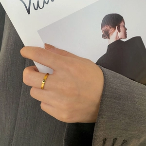 Polished 18k gold plated stainless steel wide band ring worn with fashion styling