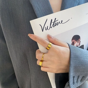 Set of three polished 18k gold plated stainless steel rings shown on model hands