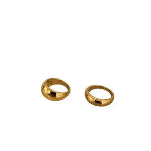 Set of two minimalist 18k gold plated stainless steel dome and wavy rings on white background