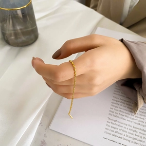 Elegant gold beaded chain bracelet in minimalist titanium steel for women held by hand