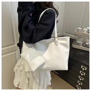 White large tote bag detail showing FASHION logo and matching small pouch charm