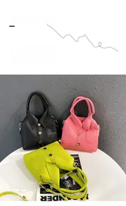 Detailed view of three shirt-shaped handbags in black, pink, and lime green with shirt collars