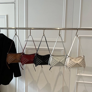 Studded leather underarm bag collection in five colors with silver rivet envelope flap