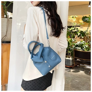 Blue lychee leather handbag featuring creative suit collar design and metal buttons