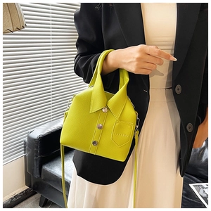 Close-up of neon yellow leather handbag with unique shirt collar design and silver buttons