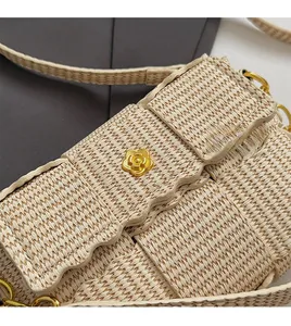 Detailed close-up of beige woven texture featuring a gold camellia flower ornament
