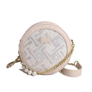 Beige round crossbody bag with pearl chain strap and intricate floral embroidery details