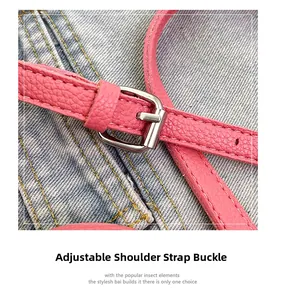 Detail of pink lychee leather strap with adjustable silver metal buckle on denim background