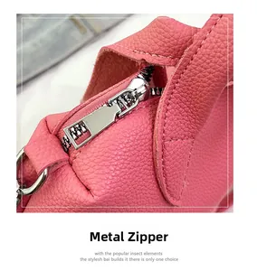 Macro shot of pink lychee leather texture and high-quality silver metal zipper detail