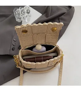 Detail of beige woven straw bag interior with spacious compartments and magnetic closure
