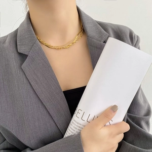 Layered gold snake bone and chunky chain necklace set for a modern minimalist jewelry look