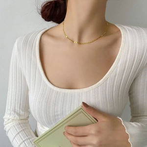 Collier chaîne ancre nez de porc doré sur mannequin en pull en maille blanc