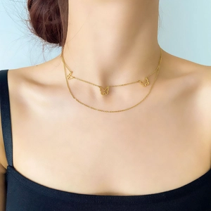 Double-layer gold butterfly pendant necklace for women with minimalist choker chain design