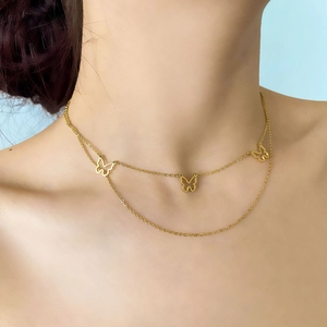 Close-up of double-layer gold butterfly necklace with delicate layered chain design
