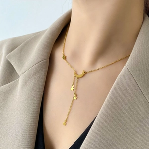 Détail du collier à pampilles étoile et lune dorées avec croissant élégant