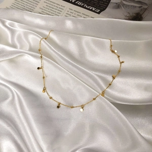 Minimalist 18k gold plated stainless steel necklace with small discs and beads on satin