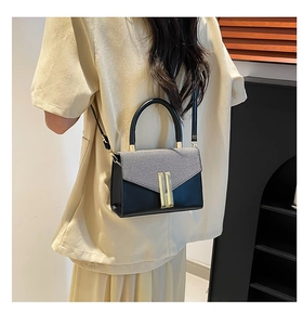 Detailed back view of a chic black and grey crossbody square bag with gold metal buckle