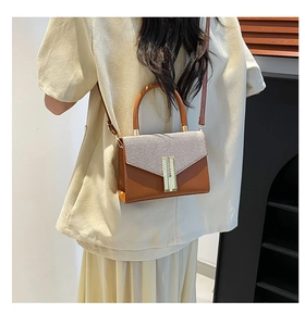 Detailed back view of a minimalist square crossbody bag with brown leather and grey fabric