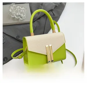 Detail of lime green leather and woven beige flap with vertical gold metal bar clasp