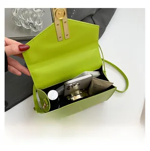 Internal capacity of neon green crossbody bag showing space for phone and makeup