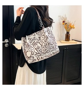 Detail of white graffiti tote bag with vintage drawings and leather chain strap