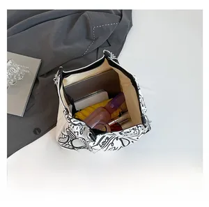 Interior view of large graffiti canvas tote showing tablet, phone, and umbrella capacity