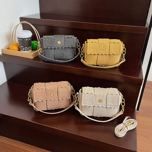 Fashionable woven crossbody bags in four colors on stairs with elegant chain straps