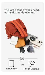 Detail of orange nylon chest bag showing large capacity for iPad, phone and accessories