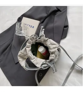 Detail view of silver bucket bag with drawstring closure showing spacious interior storage