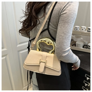 Detail of canvas shoulder bag with golden arch handle and signature H buckle clasp
