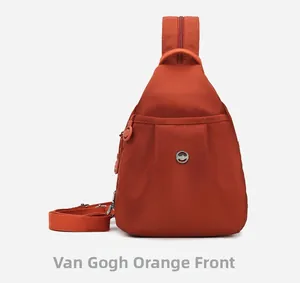 Front view of Van Gogh Orange nylon chest bag showing zipper pocket and metallic logo detail