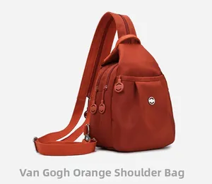 Detailed side view of multi-compartment nylon chest bag in Van Gogh orange with zip pockets