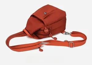 Detail of van gogh orange oxford fabric crossbody chest bag with triple zipper pockets