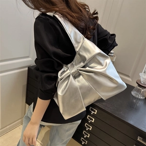 Silver metallic bow shoulder bag for women with modern minimalist hobo tote design