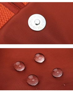 Detail of waterproof oxford fabric and silver snap button on the mini red backpack