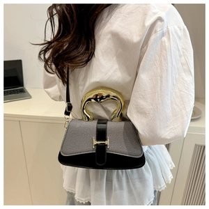 Detail of contrast square handbag with liquid metal handle and adjustable crossbody strap