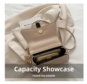 Top view of compact beige crossbody bag showing interior space for phone and wallet
