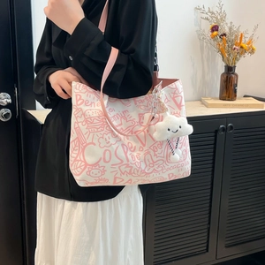 Graffiti canvas tote bag with pink straps and plush cloud charm for school and commuting
