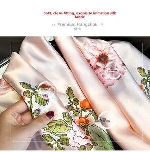 Detail of soft silk-like fabric featuring elegant pink peony floral print and smooth texture