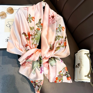 Floral pink silk scarf with vintage satin finish displayed with stylish accessories
