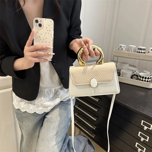 Minimalist white leather crossbody bag with beige woven flap and gold metal handle