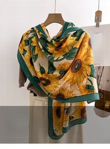 Detail of soft sunflower print scarf on wooden hanger with stylish autumn accessories
