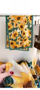Detail of sunflower print scarf showing soft imitation cashmere texture and vibrant pattern