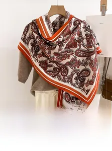 Detail of red and orange paisley pattern scarf made of soft imitation cashmere wool